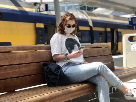 Een reiziger met een mondkapje, foto: NS